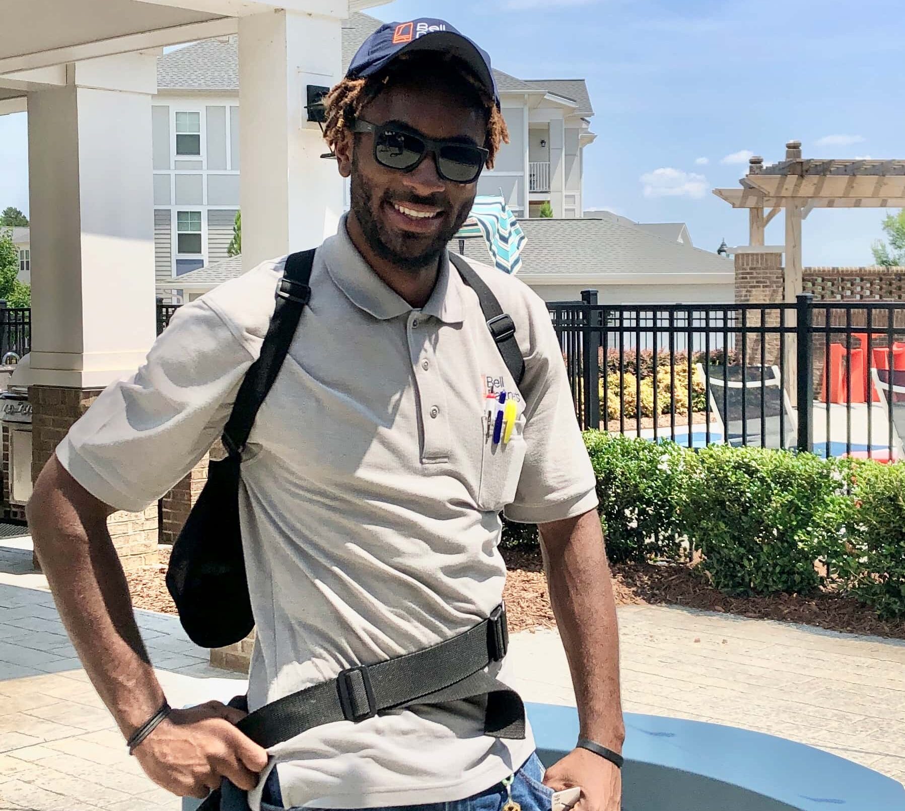 Man standing outside pool area in work belt