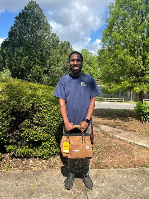 Entryway Maintenance Tech at job site with tool bag provided by Chadwell Supply