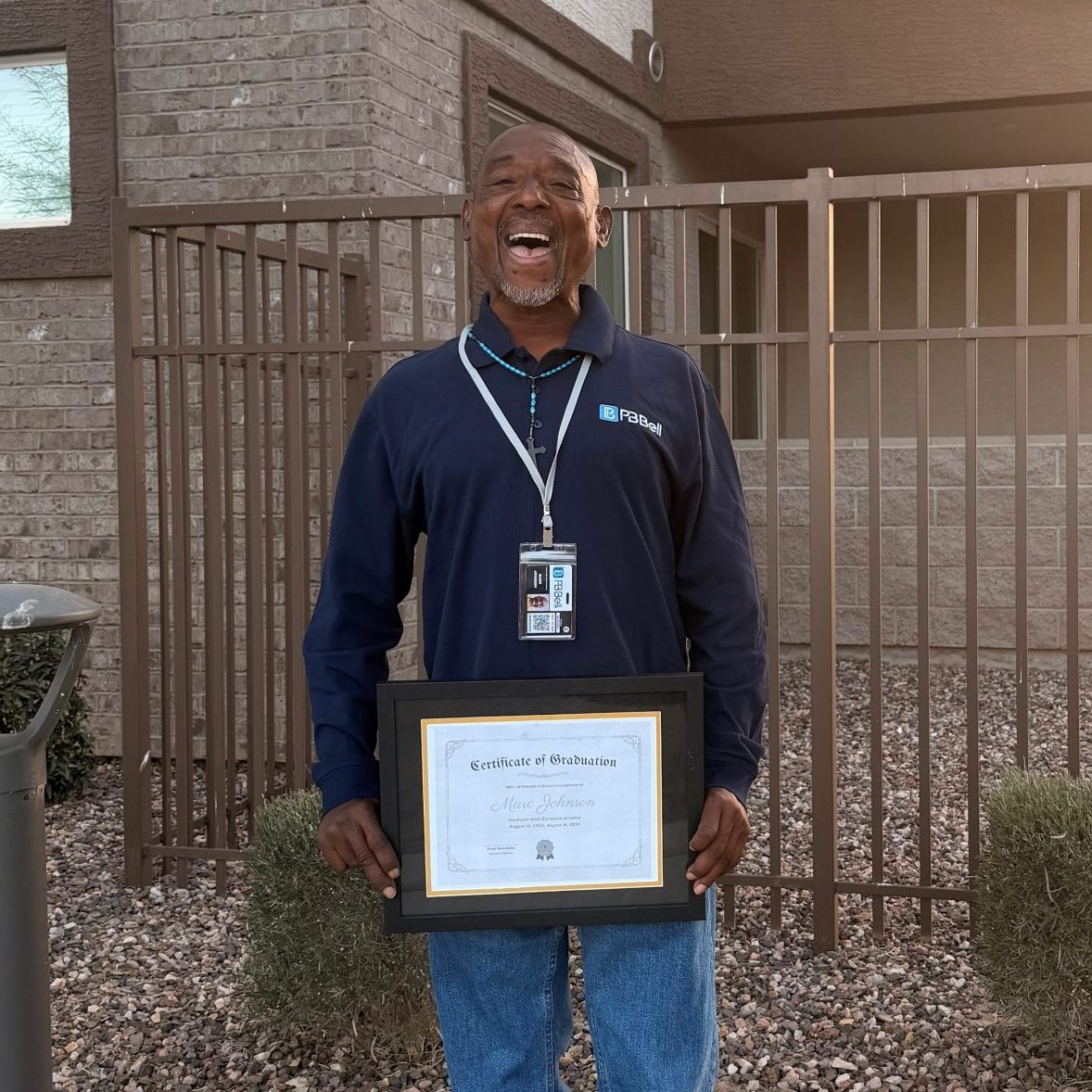 Entryway participant holds graduation certificate